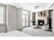 Spacious bedroom with fireplace, sitting area, and access to balcony at 105 Fillmore St # 204, Denver, CO 80206