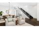 Open concept dining area with a large wooden table and modern chandelier at 105 Fillmore St # 204, Denver, CO 80206