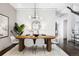 Modern dining room with a long wooden table and stylish chairs at 105 Fillmore St # 204, Denver, CO 80206