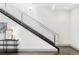 Modern staircase with sleek metal railing and dark wood steps at 105 Fillmore St # 204, Denver, CO 80206