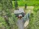 Aerial view of a home with mature trees, a large driveway, and a cozy porch at 31258 Niakwa Rd, Evergreen, CO 80439