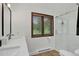 Bright bathroom featuring a glass-enclosed shower, wood-look flooring, and a white vanity at 31258 Niakwa Rd, Evergreen, CO 80439