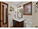 Bathroom with a vanity, wood accents, decorative artwork, and toilet at 31258 Niakwa Rd, Evergreen, CO 80439