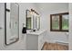 Bright bathroom with double vanity, modern mirrors, and white cabinets at 31258 Niakwa Rd, Evergreen, CO 80439