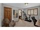 Bedroom with wood-trimmed windows, neutral color, and exercise equipment at 31258 Niakwa Rd, Evergreen, CO 80439