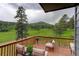 Outdoor deck with scenic views, comfortable seating, and a tranquil environment at 31258 Niakwa Rd, Evergreen, CO 80439