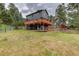 Two-story home with a spacious, multi-level deck perfect for outdoor living at 31258 Niakwa Rd, Evergreen, CO 80439