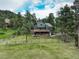 Charming two-story home with a spacious deck nestled among mature pine trees at 31258 Niakwa Rd, Evergreen, CO 80439