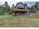 Inviting two-story home featuring dual decks and lush green surroundings at 31258 Niakwa Rd, Evergreen, CO 80439