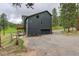Back of house featuring a dark grey color, balcony, garage, and mountain views at 31258 Niakwa Rd, Evergreen, CO 80439