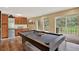 Bright game room with a pool table, wood cabinets and a sliding glass door to the deck at 31258 Niakwa Rd, Evergreen, CO 80439