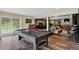 Spacious game room with a pool table, dartboard, and comfortable seating area for entertainment at 31258 Niakwa Rd, Evergreen, CO 80439