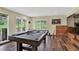 Game room with a pool table, dartboard, and a sliding glass door leading to the outdoors at 31258 Niakwa Rd, Evergreen, CO 80439