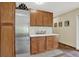 Kitchenette area featuring wood cabinets, stainless steel refrigerator, and a marble countertop at 31258 Niakwa Rd, Evergreen, CO 80439