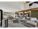 Open-concept living room features a gray sectional couch, hardwood floors and dining area at 31258 Niakwa Rd, Evergreen, CO 80439