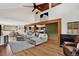 Inviting living room boasts hardwood floors, an open layout, and comfortable gray furniture at 31258 Niakwa Rd, Evergreen, CO 80439