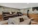 Relaxing living room featuring plush couches, wood paneling, and a pellet stove at 31258 Niakwa Rd, Evergreen, CO 80439