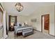 A bright bedroom features a pendant light, gray accents and an adjoining door to another room at 31258 Niakwa Rd, Evergreen, CO 80439