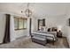 Bright bedroom featuring a large bed with decorative pillows, pendant lighting and neutral colors at 31258 Niakwa Rd, Evergreen, CO 80439