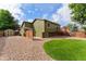 Backyard featuring a deck, storage shed and fenced yard at 13849 W 66Th Dr, Arvada, CO 80004