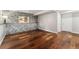 Spacious basement featuring a stone accent wall and hardwood floors at 13849 W 66Th Dr, Arvada, CO 80004