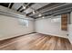 Basement rec room featuring wood floors, recessed lighting, and egress windows at 13849 W 66Th Dr, Arvada, CO 80004