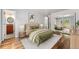 This bedroom features hardwood floors, a view of the deck, and an ensuite bath at 13849 W 66Th Dr, Arvada, CO 80004