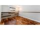 Bedroom featuring new wood floors, natural light, and decorative wood accent at 13849 W 66Th Dr, Arvada, CO 80004