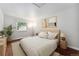 Cozy bedroom featuring a large window with natural light and hardwood floors at 13849 W 66Th Dr, Arvada, CO 80004