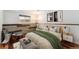 Bedroom featuring stylish decor, natural light, and wood accent wall at 13849 W 66Th Dr, Arvada, CO 80004