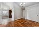 Bright dining room with hardwood floors, a modern chandelier, and access to the kitchen at 13849 W 66Th Dr, Arvada, CO 80004