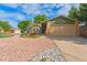 Inviting exterior with a lush front yard, rock features, manicured lawn, and two-car garage at 13849 W 66Th Dr, Arvada, CO 80004