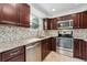 Modern kitchen featuring stainless steel appliances, granite countertops, and mosaic backsplash at 13849 W 66Th Dr, Arvada, CO 80004