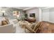 Basement living room with stone accent wall and stylish furniture at 13849 W 66Th Dr, Arvada, CO 80004