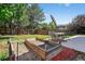Large backyard features a garden, grass area, nice wooden fence, and patio with dining set at 10343 Stoneflower Dr, Parker, CO 80134
