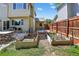 Backyard features raised garden beds, patio area, and privacy fence, perfect for outdoor living at 10343 Stoneflower Dr, Parker, CO 80134