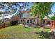 Large backyard with patio area, mature trees, lush lawn, and privacy fence, is great for entertaining at 10343 Stoneflower Dr, Parker, CO 80134