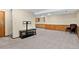 Finished basement with gray carpet, wood trim, and potential wet bar area for entertaining or relaxation at 10343 Stoneflower Dr, Parker, CO 80134