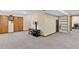 Spacious basement area with gray carpet, recessed lighting, closet, and shelving for storage or decor at 10343 Stoneflower Dr, Parker, CO 80134