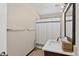 Bright bathroom featuring a single vanity with solid surface counters and tiled floors at 10343 Stoneflower Dr, Parker, CO 80134