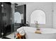 Stunning bathroom featuring a luxurious soaking tub, walk-in shower, and modern black-and-white design at 10343 Stoneflower Dr, Parker, CO 80134