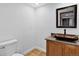 Stylish half bath features unique sink basin, vanity, tile flooring, and modern fixtures at 10343 Stoneflower Dr, Parker, CO 80134