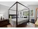 Bright bedroom boasts a four-poster bed, lots of light, and pretty outdoor views at 10343 Stoneflower Dr, Parker, CO 80134