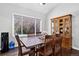 Dining room with wood table, chairs, china cabinet, and a large window at 10343 Stoneflower Dr, Parker, CO 80134
