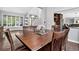 Dining room with hardwood floors, large table and bay window with backyard view, creating a warm and inviting space at 10343 Stoneflower Dr, Parker, CO 80134