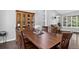 Elegant dining room with wood table, chairs, china cabinet and large window showcasing an abundance of natural light at 10343 Stoneflower Dr, Parker, CO 80134