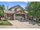 Charming home with a three-car garage, stone accents, and well-maintained landscaping in a suburban neighborhood at 10343 Stoneflower Dr, Parker, CO 80134