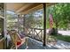 Inviting front porch showing classic wood railing, comfortable wicker seating with an American flag waving in the breeze at 10343 Stoneflower Dr, Parker, CO 80134