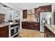 Well-appointed kitchen features stainless steel appliances, stone countertops, and dark wood cabinetry at 10343 Stoneflower Dr, Parker, CO 80134
