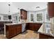 Open-concept kitchen with stainless steel appliances, stone countertops and view to living room at 10343 Stoneflower Dr, Parker, CO 80134